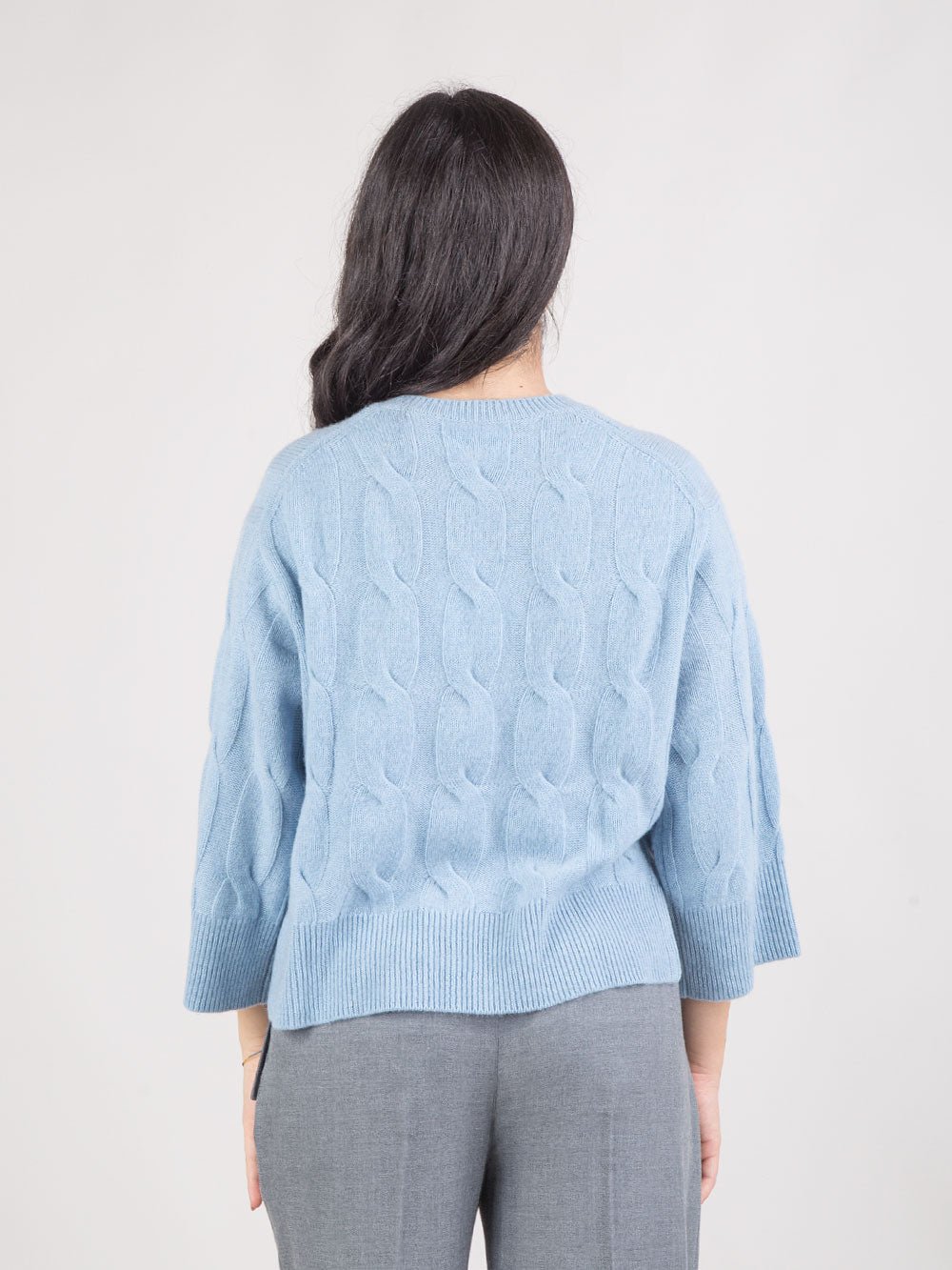 PONCHO IN MAGLIA A TRECCE